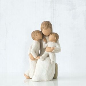 Quietly sculpted figurine by Susan Lordi . Willow Tree